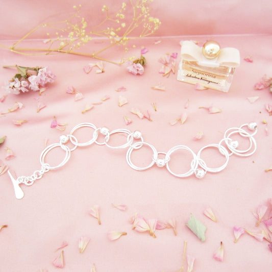 Pulsera plateado argollas dobles bolitas