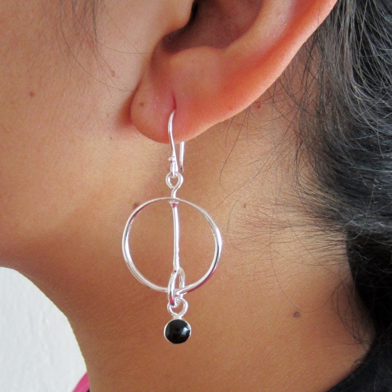 Silver hoop earrings in synchrony