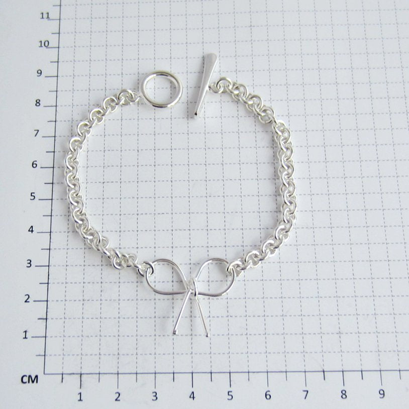 Pulsera plateada moñito